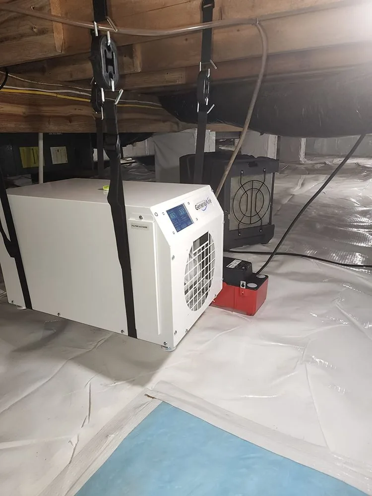 Dehumidifier running under a Bay Area subfloor on protective sheeting